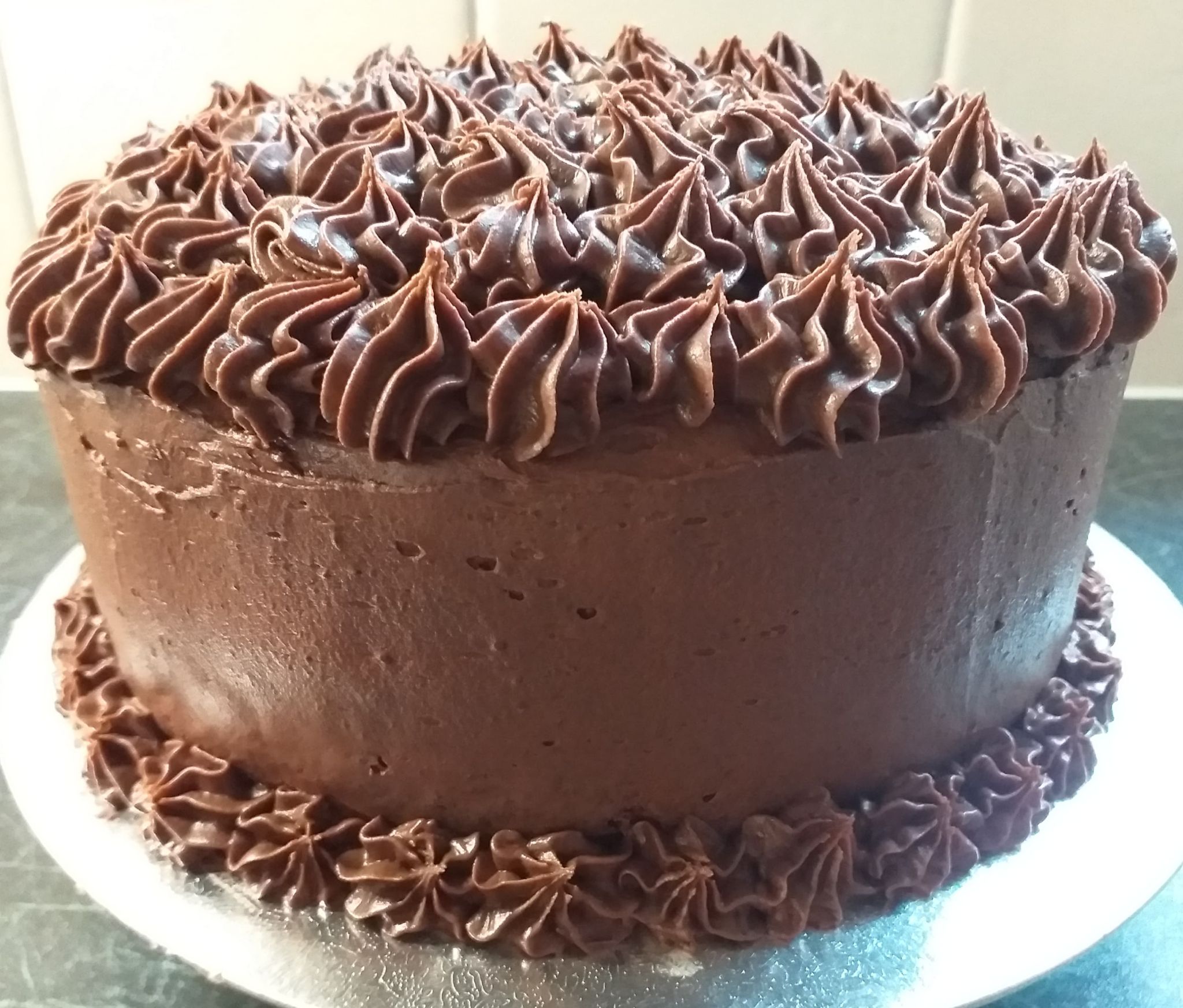 A very chocolatey cake with frosted icing.